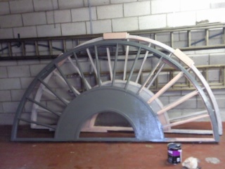Meanwhile Susan paints primer to the semi-circular wheel in two halves ready to be set in place.